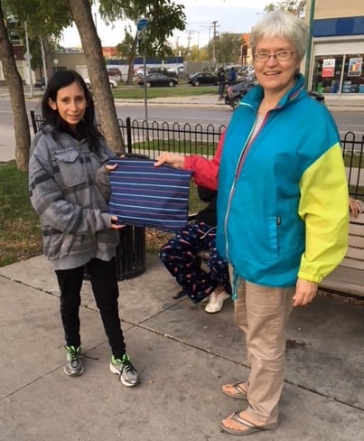 Dawn (left) receives a toiletry kit from H2O Team Member Donna (right). Donna and Ron also prayed for Dawn.